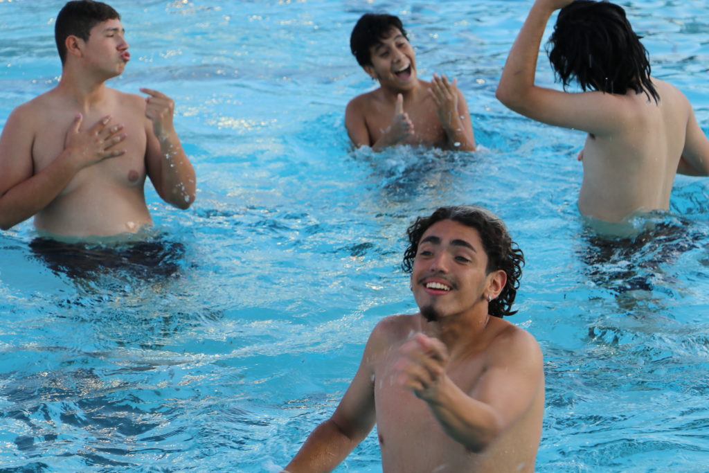 Four teen boys in pool.