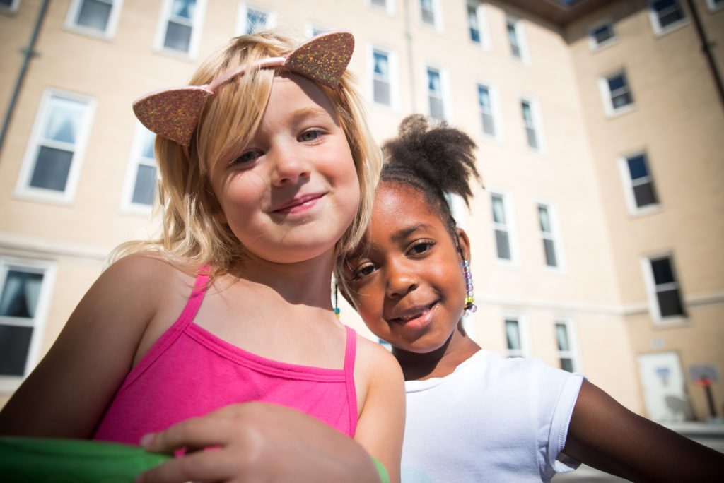 Girl with headband with cat ears and friend.