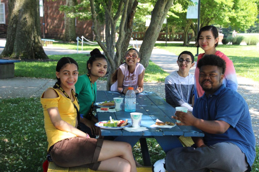 Six middle school students sitting around picnic table.